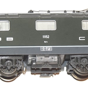 May include: A green and gray model train locomotive with the text "SBB 11152 CFF" on the side.
