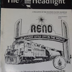 May include: A black and white illustration of a train engine pulling a train car. The train is passing under a sign that reads "Reno, The Biggest Little City in the World". The train is labeled "Western Pacific" and has the number "3009" on the side. The train is also labeled "Military Blood Procurement Car".