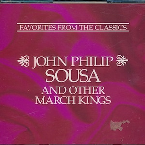 May include: A pink CD case with the text "Favorites from the Classics" and "John Philip Sousa and Other March Kings" in white.