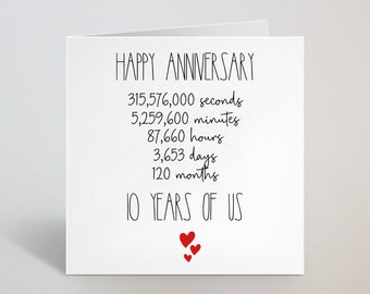 May include: A white anniversary card with the text "HAPPY ANNIVERSARY" and time measurements in seconds, minutes, hours, days, and months. The card also reads "10 YEARS OF US" with three red hearts.