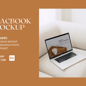 May include: A white laptop computer with a silver lid is open on a white sofa. The screen displays a website for a luxury coffee company. The text "Luxury coffee company" is visible on the screen.