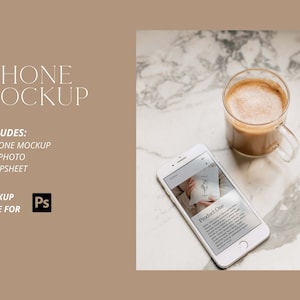 Può includere: Un mockup di iPhone bianco con uno schermo che mostra una pagina di prodotto con il testo "Product One". Il telefono è su una superficie di marmo bianco con un bicchiere di caffè.