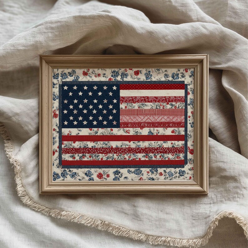 Framed American flag quilt wall art displayed on soft linen fabric with red, white and blue floral pattern details.