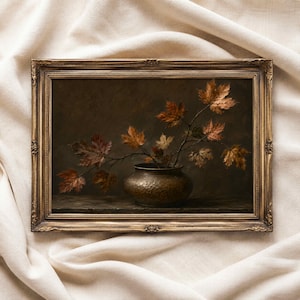 May include: A framed oil painting depicting a hammered bronze-toned bowl holding a branch with dried autumn maple leaves in shades of brown, orange, and gold. The artwork is enclosed in an ornate, antique-style gold frame with detailed carvings.