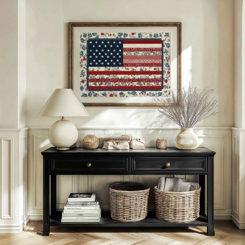 Framed American flag quilt wall art styled above a black console table with baskets, lamp and neutral farmhouse decor.