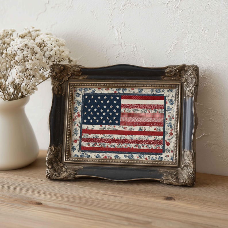 Small framed American flag quilt wall art displayed on a wooden shelf with a white vase and soft neutral farmhouse decor.