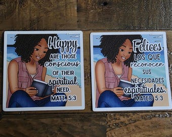 May include: Two square coasters with illustrations of a woman reading a book. One coaster has the text "Happy are those conscious of their spiritual need. Matt. 5:3." The other says "Felices los que reconocen sus necesidades espirituales. Mateo 5:3."