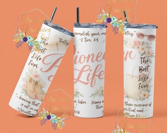 May include: White insulated tumblers with floral designs and text. One tumbler reads "The Best Life Ever" with ballet flats, another says "Pioneer Life", and the third says "The Best Life Ever" with sunglasses. Each has a straw.