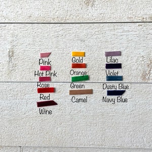 May include: A collection of fabric swatches in various colors, including pink, hot pink, rose, red, wine, gold, orange, lilac, violet, green, dusty blue, camel, and navy blue.