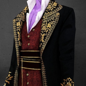 May include: A black jacket with gold embroidery and a red vest with gold buttons. The jacket has a high collar and a long, flowing style.