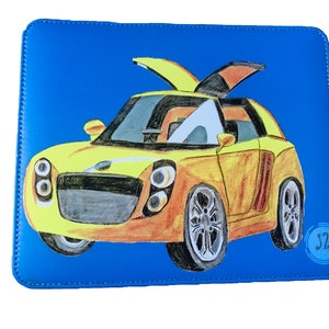 May include: A blue leather notebook cover featuring an illustration of a yellow car. The car has an open door and a black interior. The artist's signature "J2" is in the bottom right corner.
