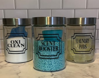 May include: Three glass jars with silver lids, labeled "Oxi Clean", "Scent Booster", and "Laundry Pods". The jars are filled with white powder, blue beads, and clear laundry pods.