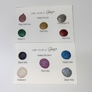 May include: Two cards displaying swatches of glitter in a range of colours, including rose gold, gold, green, red, black, ocean blue, pink, iridescent, and silver. The cards are labelled "with a touch of Grace" and "Holiday Dot Card" and "Holiday Dot Card II".