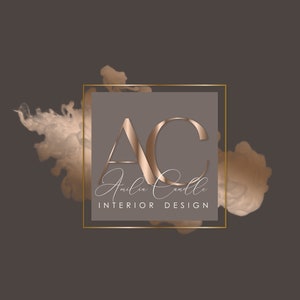 May include: A gold square frame with a grey background and the letters "AC" in a metallic gold font. The text "Amelia Candle Interior Design" is written in cursive below the letters.
