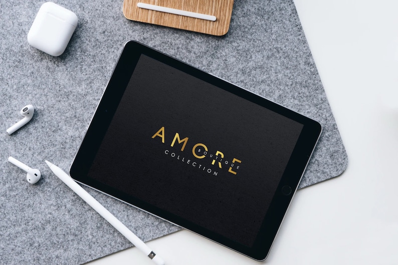 May include: A black tablet with a gold logo that says "AMORE BOUTIQUE COLLECTION" on the screen.