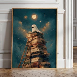 May include: A framed wall art print depicting a white ghost sitting atop a tall, precarious stack of various books under a glowing full moon in a dark, starry night sky. A wooden ladder leans against the side of the book tower.