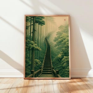 May include: A framed vertical art print featuring a long wooden staircase winding upward through a dense, misty forest of tall green trees. The scene is rendered in soft, muted shades of green and beige, with a small red square seal in the corner.