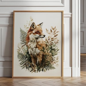 May include: A framed wall art print featuring a detailed illustration of a red fox with white and orange fur, positioned amidst a cluster of green fern leaves and light brown foliage against a plain, off-white background.