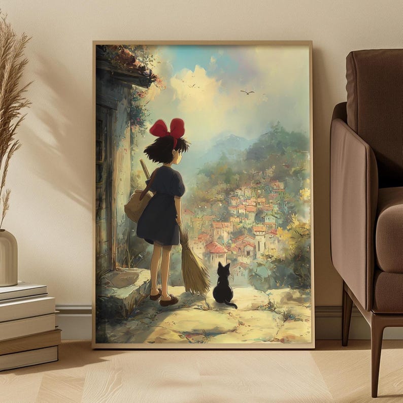 May include: A framed print of an anime scene. A young girl with a red bow stands with a broom and a black cat, overlooking a village. The artwork features a vibrant color palette with a focus on the landscape and the characters.
