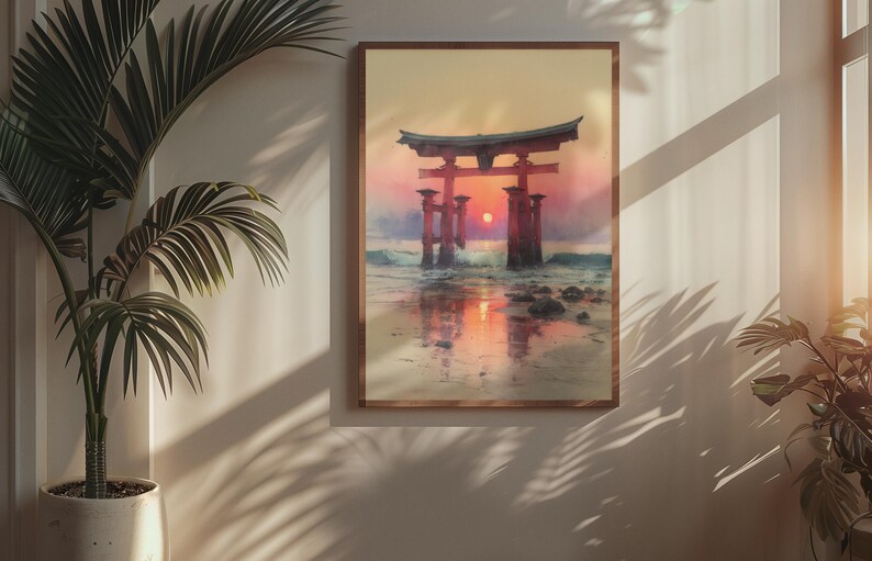 May include: A framed print of a Japanese torii gate at sunset. The artwork depicts the gate in the water with the sun setting behind it, creating a warm, orange and red color palette. The frame is a light brown color.