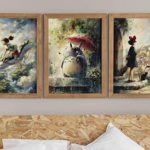 K&ouml;nnte beinhalten: Set aus drei gerahmten Kunstdrucken mit Aquarellillustrationen. Einer zeigt ein M&auml;dchen, das auf einem Drachen reitet, ein anderer ein gro&szlig;es Wesen mit einem Regenschirm und der dritte ein M&auml;dchen mit einer schwarzen Katze.