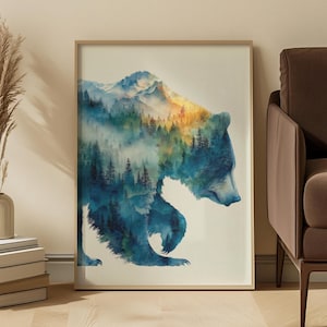 May include: A framed watercolour print depicting a bear silhouette filled with a forest and mountain landscape. The artwork uses shades of blue, green, and yellow, creating a nature-inspired scene. The print is in a light-coloured wooden frame.