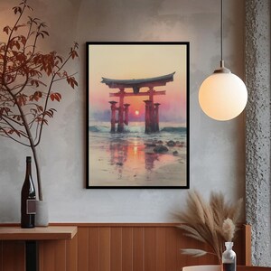 May include: Framed art print of a Japanese torii gate at sunset. The artwork depicts the gate in the ocean with the sun setting between the pillars, reflecting on the water. The sky transitions from orange to pink.