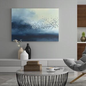 May include: A rectangular wall art print featuring a large flock of small black birds flying across a gradient sky that transitions from deep navy blue on the left to a pale, soft cream color on the right side of the horizontal composition.