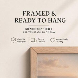 May include: A light wood picture frame with a partial view of a landscape print. Text reads: FRAMED & READY TO HANG, NO ASSEMBLY NEEDED, ARRIVES READY TO DISPLAY, Carefully Packaged, Secure Delivery, Arrives Ready To Enjoy with icons.