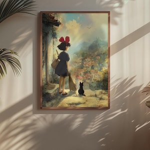 May include: A framed print featuring a young girl with a red bow, black dress, and a broom, standing with a black cat. The artwork depicts a village scene with a soft, painterly style, evoking a sense of fantasy and adventure.