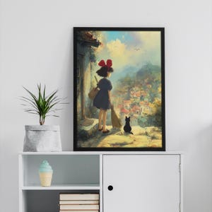 May include: Framed art print featuring a young girl with a red bow, a black cat, and a broom, overlooking a village. The artwork has a painterly style with a vibrant sky and detailed buildings. The girl wears a dark blue dress and carries a bag.
