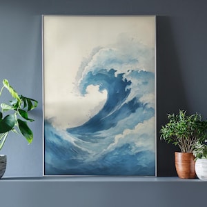 May include: A framed art print featuring a watercolor depiction of a large ocean wave. The wave is rendered in shades of blue and white, with a foamy crest. The artwork is displayed in a silver frame, evoking a sense of the sea.