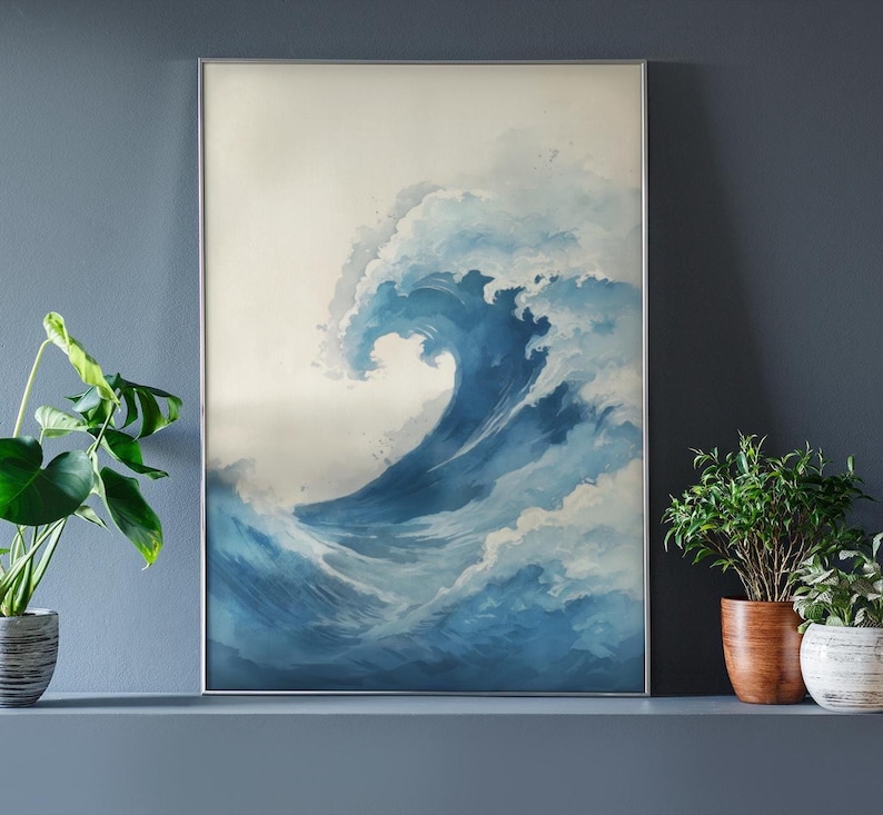 May include: A framed art print featuring a watercolor depiction of a large ocean wave. The wave is rendered in shades of blue and white, with a foamy crest. The artwork is displayed in a silver frame, evoking a sense of the sea.