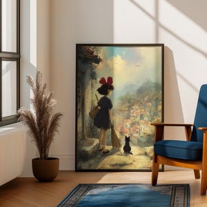 May include: Framed art print featuring an anime-style illustration of a young girl with a red bow, broom, and black cat, overlooking a village. The artwork has a warm color palette and is displayed in a room with a blue chair and a decorative plant.