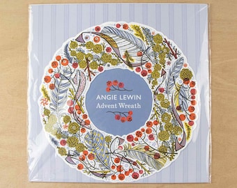 May include: A square card featuring a circular wreath illustration with orange berries, yellow flowers, and blue-toned feathers. The center blue circle contains the white text: ANGIE LEWIN Advent Wreath. The card has a light blue striped background.