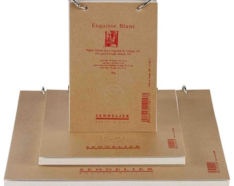 May include: A stack of three brown sketchbooks with a white paper cover. The top sketchbook has a label that reads "Esquisse Blanc" and "Papier Dessin pour esquisse & croquis, DI. For pencil rough sketch, DI." The label also includes the brand name "SENNELIER".