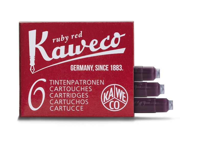 May include: A red box of Kaweco ruby red ink cartridges. The box has white text that reads "Kaweco" and "Germany, Since 1883." The box contains six cartridges. Three cartridges are visible, showing the dark red ink.