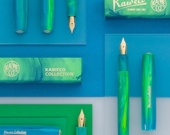 May include: Kaweco Collection fountain pens featuring a marbled teal and green resin body with gold-toned nibs. The set includes matching rectangular boxes with the text Kaweco Collection and the Kaweco logo printed in a white halftone dot pattern.