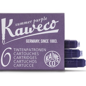 May include: A box of Kaweco summer purple ink cartridges. The box is a deep purple color and features the Kaweco logo and text in white. The box contains six ink cartridges, with three visible. The text on the box includes "Germany, Since 1883."