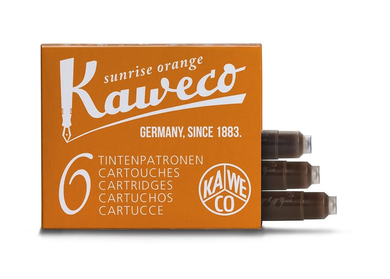 May include: Orange box of Kaweco sunrise orange ink cartridges. The box has the Kaweco logo and text that reads "GERMANY, SINCE 1883." The box contains six cartridges. Three cartridges are visible.