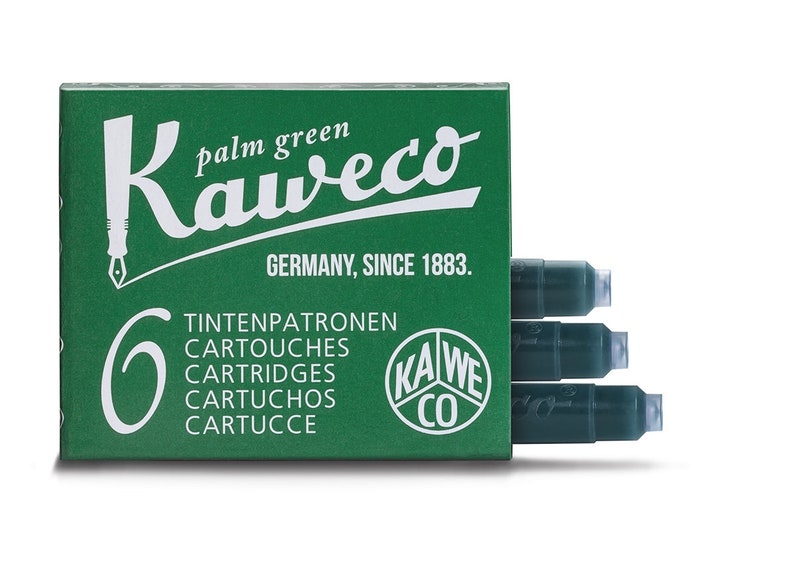 May include: A green box of Kaweco palm green ink cartridges. The box has white text that reads "Kaweco" and "Germany, Since 1883." The box contains six cartridges. The cartridges are dark green.