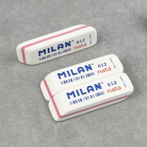May include: Three white erasers with pink edges and blue text. The erasers are stacked on top of each other. The text on the erasers reads "MILAN® 612 nata made in SPAIN".