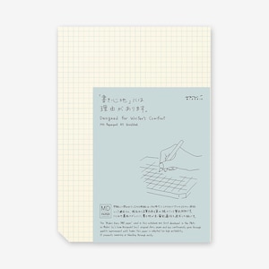 Könnte beinhalten: Ein hellblaues Notizbuch mit einem karierten Design. Der Umschlag zeigt eine Hand, die einen Bleistift hält, und den Text "'Schreiben' hat einen Grund."  "Designed for Writer's Comfort" und "MD Paperpad AS Gridded" sind ebenfalls auf dem Umschlag aufgedruckt.