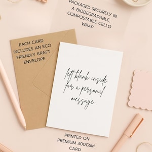 May include: A stationery flat lay featuring a white card with the text "left blank inside for a personal message", a kraft envelope, and a pen. The card is printed on premium 300gsm card. Other items include a paper clip, and a pair of scissors.