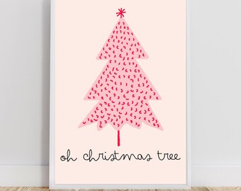 May include: A framed print with a pink Christmas tree illustration, decorated with red dashes and a red star. The words "oh christmas tree" are written in black script below the tree. The background is a pale pink colour.