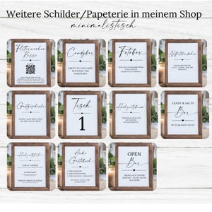 May include: A collection of framed signs with various text, including "Candybar", "Fotobox", and "Open Bar". The signs have a minimalist design with dark brown frames and white backgrounds, suitable for weddings or events.