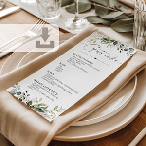May include: A menu card with a floral design, listing various drinks. The card is on a white plate, with a beige napkin. The menu includes soft drinks, beer, wine, and hot beverages, perfect for a wedding or event.
