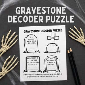 May include: A black and white Halloween-themed puzzle sheet with the text "GRAVESTONE DECODER PUZZLE". The sheet features tombstone graphics with number sequences for decoding. Two pencils and skeleton hands are also visible.