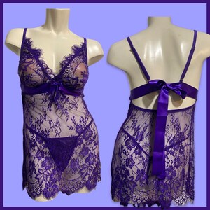 May include: Purple lace lingerie with a satin bow on the back and a matching lace panty.