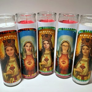 May include: Five glass candle jars with red wax and white labels. Each label features a different woman wearing a crown and holding a heart. The women are all wearing traditional religious clothing.
